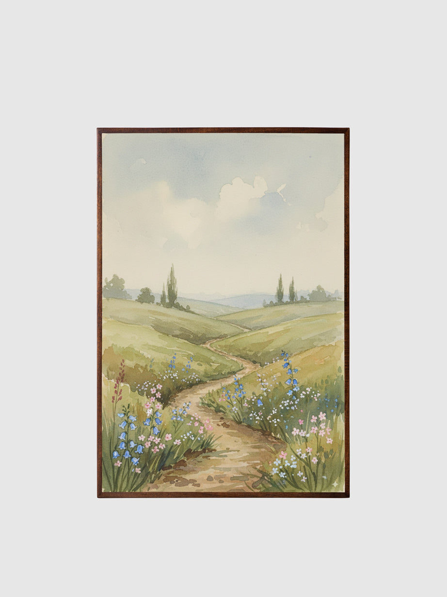 Framed painting of a landscape with a path and flowers on a white wall